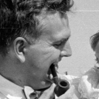 Man with pipe and girl in white dress.