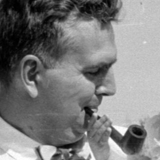 Man and young girl with a pipe outdoors.