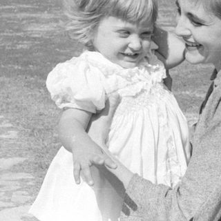 Woman and toddler in a park setting.
