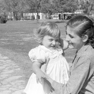 Woman and toddler in a park setting.
