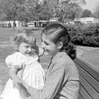 Woman and toddler in a park setting.