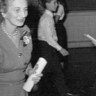 Group of people in formal wear indoors.