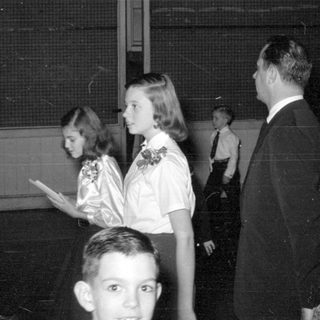 Group of people in formal wear indoors.