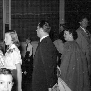 Group of people in formal wear indoors.