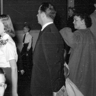 Group of people in formal wear indoors.
