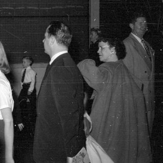 Group of people in formal wear indoors.