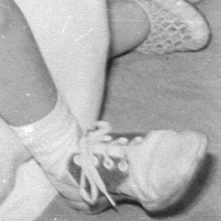 Woman and boy in sailor suit on carpet.