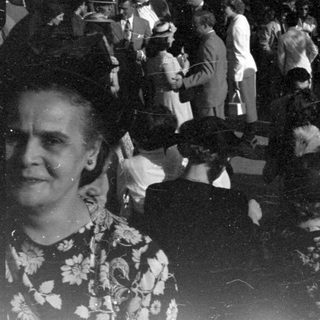 Crowd in formal attire in a dark indoor venue.
