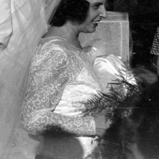 Wedding party in formal attire, black and white.