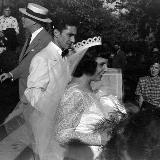 Wedding party in formal attire, black and white.