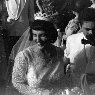 Wedding couple and guests in formal attire.