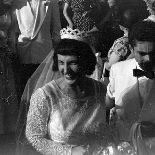Wedding couple and guests in formal attire.