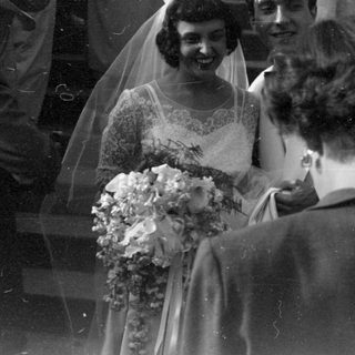 Bride with tiara and bouquet at a wedding.