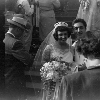 Bride with tiara and bouquet at a wedding.