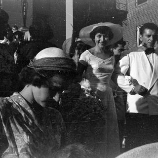 Group of people in formal attire outdoors.