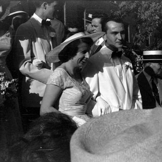 Group of people in formal attire outdoors.