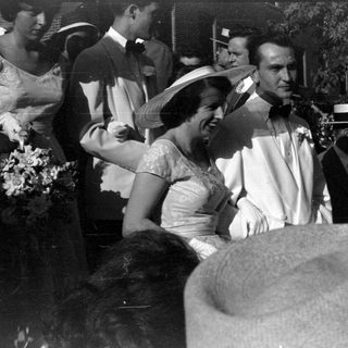 Group of people in formal attire outdoors.