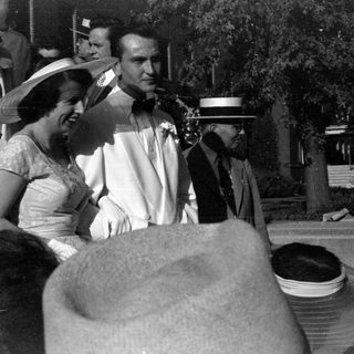 Group of people in formal attire outdoors.