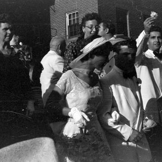 Group of people in formal attire outdoors.