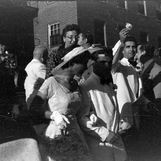 Group of people in formal attire outdoors.