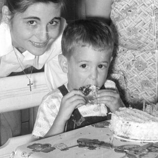 Woman, girl, and boy with a cake.