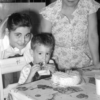 Woman, girl, and boy with a cake.