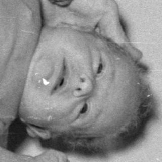 Baby being weighed on a medical scale.