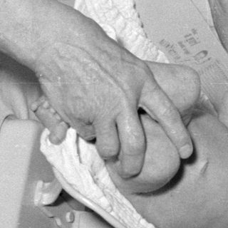 Baby being weighed on a medical scale.