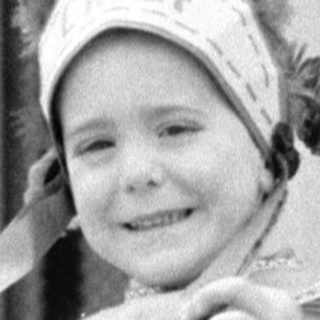Child in Native costume on steps