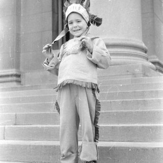 Child in Native costume on steps