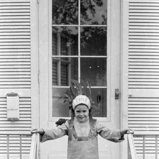 Child in chief costume on porch stairs