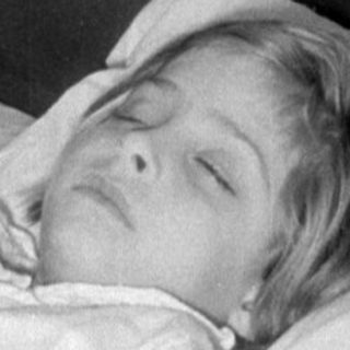 Person resting on a vintage bed