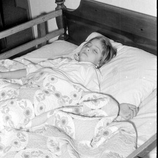 Person resting on a vintage bed