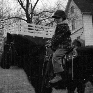 Winter horseback riding near a house
