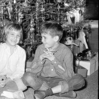 Children posing by Christmas tree