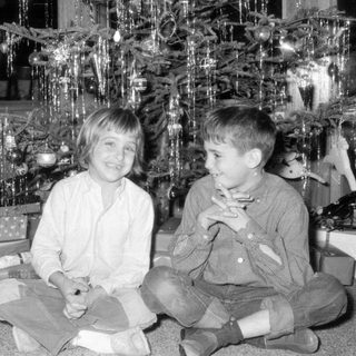 Children posing by Christmas tree