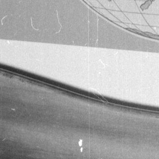 Person sleeping under sheet near map