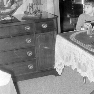 Child with model train indoors