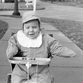 Child riding pedal cart outdoors