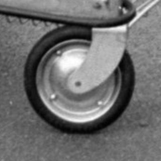 Child riding wheeled cart outdoors