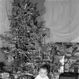 Child with Christmas tree and gifts