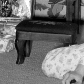 Child with Christmas tree and gifts