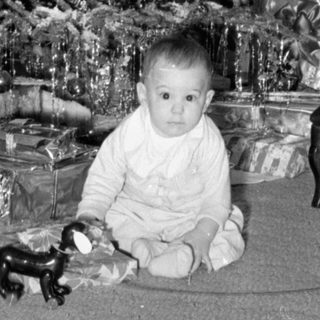 Child with Christmas tree and gifts