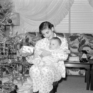 Woman and baby by Christmas tree
