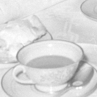 men and baby at tea table