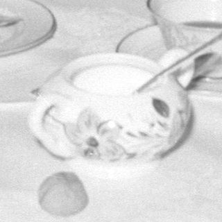 men and baby at tea table