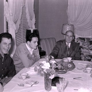 Mid-century group dinner with floral table setting