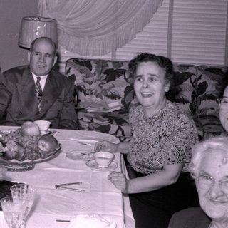 Mid-century group dinner with floral table setting