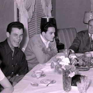 Mid-century group dinner with floral table setting