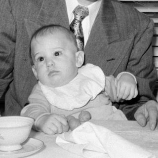 Man, baby, woman at table